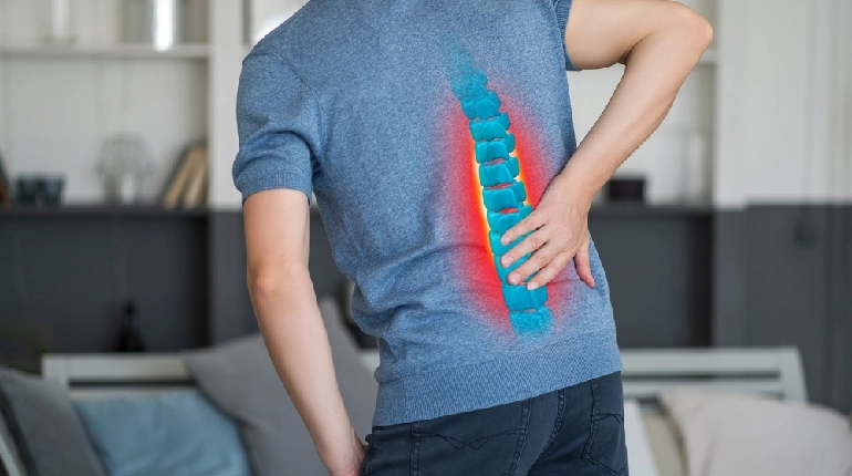 A person walking and stretching outdoors, staying active while managing degenerative disc disease naturally